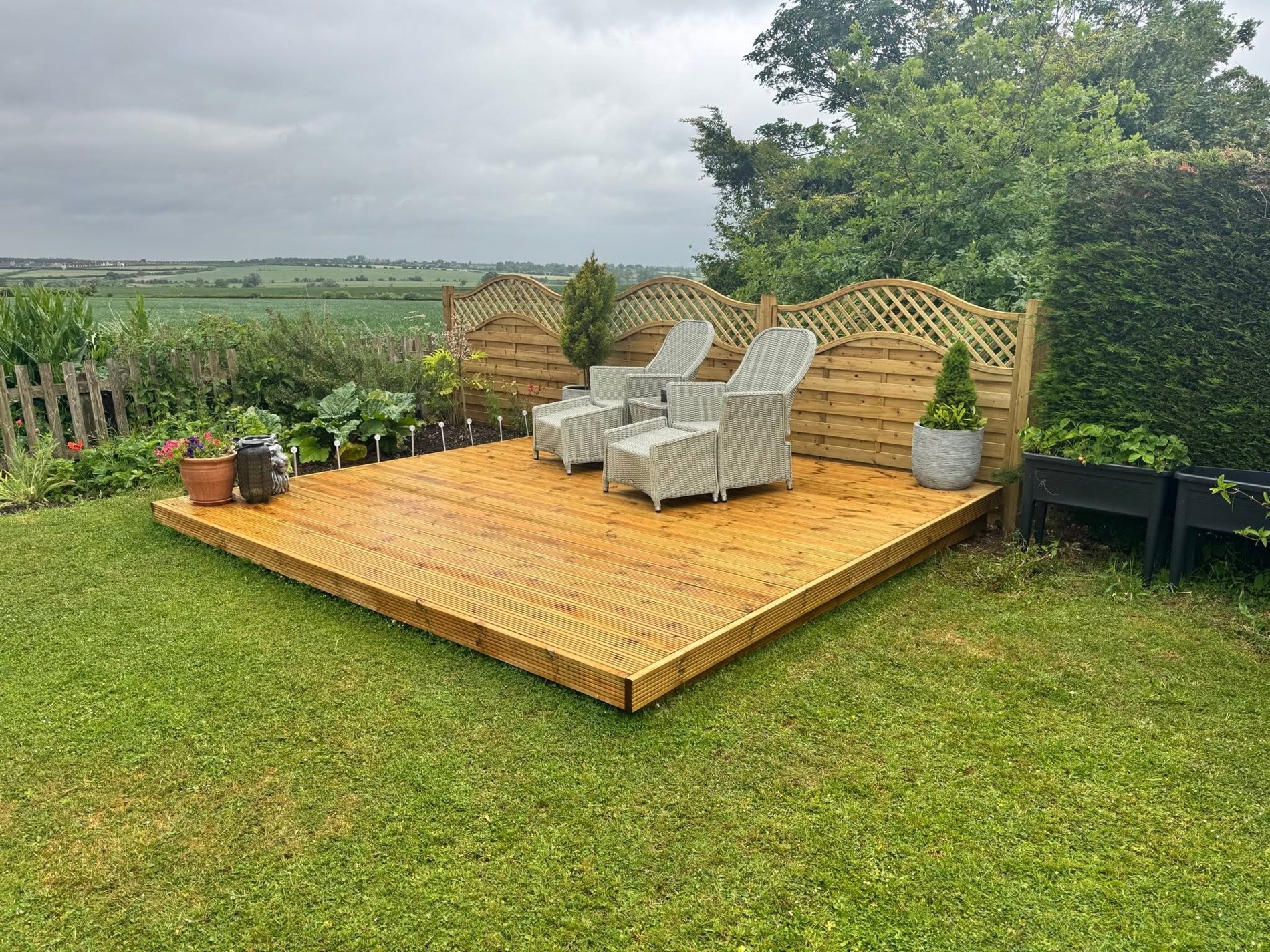 Timber deck on lawn with countryside view