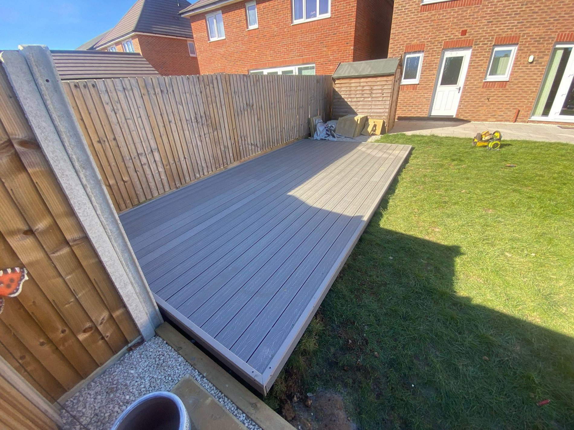 Composite deck alongside timber fence