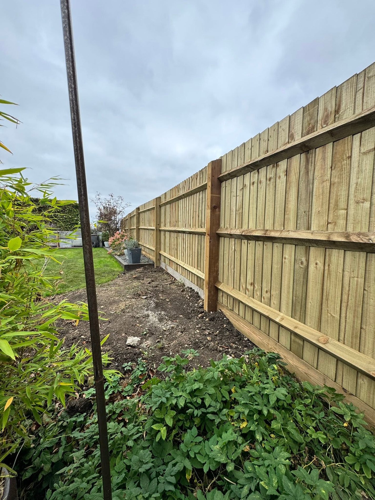 Long timber fence at garden boundary